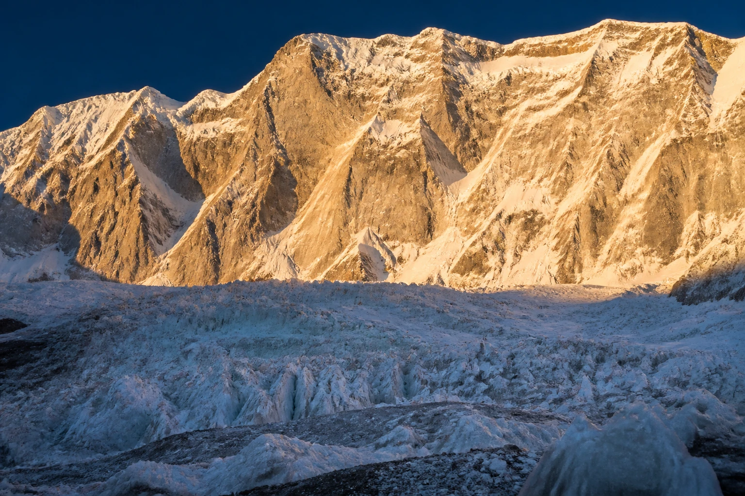 Face Rupal du Nanga Parbat, paroi rocheuse la plus haute du monde, au lever du soleil